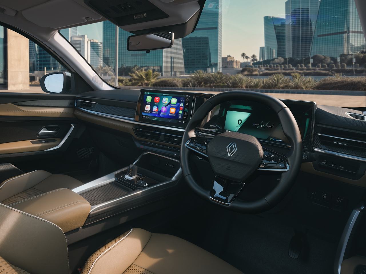 Interior of the Renault Duster strong hybrid showing the dashboard, twin screens and tan front seats